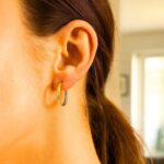 14k Two-Tone Hinged Gold Hoop Earrings 20mm x 2.5mm on model 14k Two-Tone Hinged Gold Hoop Earrings 20mm x 2.5mm on model