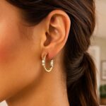 Model Wearing 14k Yellow Gold Brick Omega Hoop Earrings Model Wearing 14k Yellow Gold Brick Omega Hoop Earrings