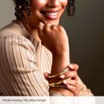 Model Wearing 14K Yellow Gold Twisted Bangle Bracelet 4mm Model Wearing 14K Yellow Gold Twisted Bangle Bracelet 4mm