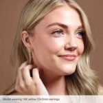 14K Yellow Gold Tube Hoop Earrings Small to Extra Large on Model