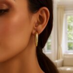 Model Wearing Large Twisted Hoop Earrings 14K Yellow Gold Model Wearing Large Twisted Hoop Earrings 14K Yellow Gold